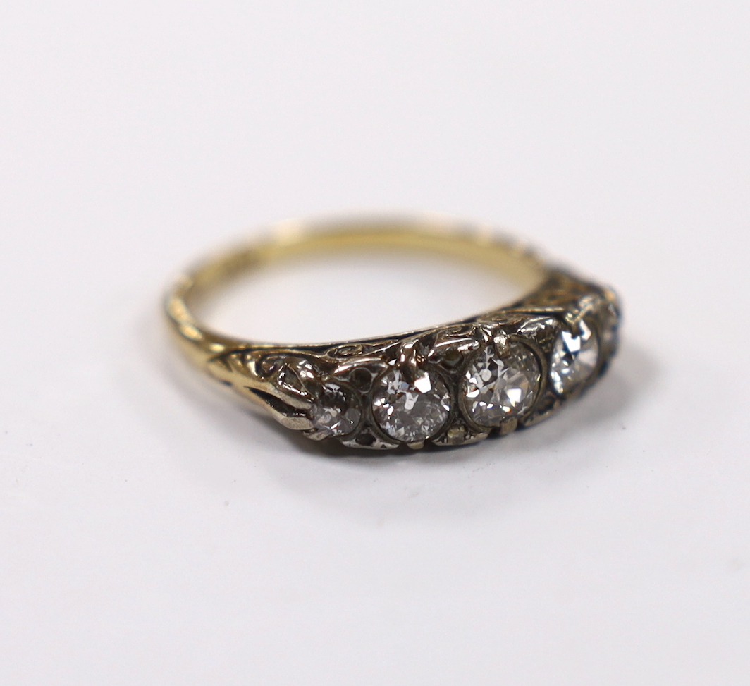 An early 20th century 18ct, plat and graduated five stone diamond set half hoop ring, with diamond chip spacers (four missing), size O, gross weight 4.3 grams.